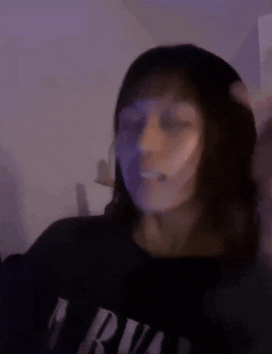 a blurry picture of a woman making a funny face .