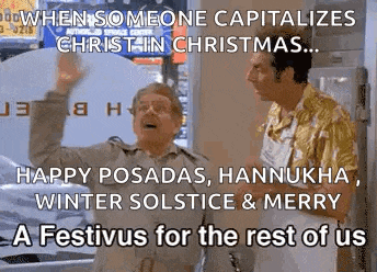 two men are standing next to each other in a room with a sign that says when someone capitalizes christ in christmas .