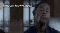 a man is making a funny face with the words `` thought we was boyz '' written above him .