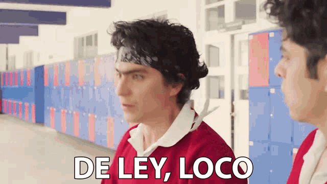 a man in a red shirt says de ley loco in front of lockers