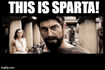 a man with a beard is looking at the camera with the words `` this is sparta '' above him .