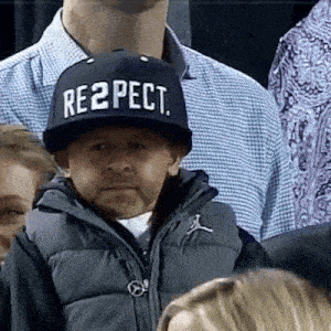 a man wearing a hat that says respect on it .