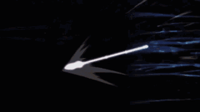 a person is standing in a dark room with a glowing object in the background