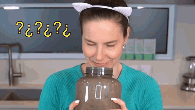 a woman in a cat ear headband holds a jar with the number 10 on it