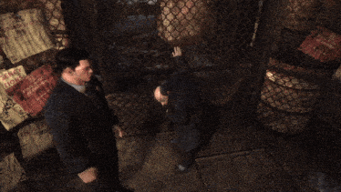 a man in a suit stands in front of a fence with posters on it including one that says ' jerry '