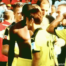 a man in a yellow shirt with the number 9 on it is hugging another man