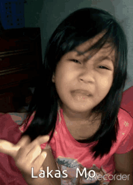 a little girl in a pink shirt with the name lukas on the bottom right