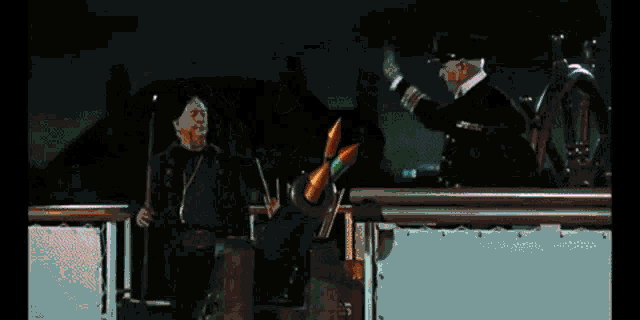 a man is standing on a boat looking at a huge explosion coming out of a cannon .