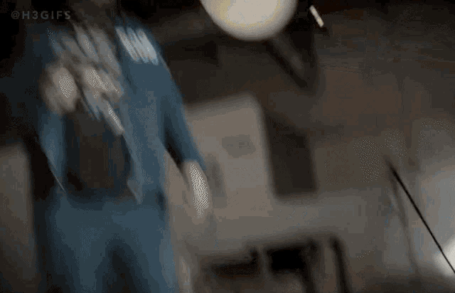 a man in a blue jacket is holding a sword and a balloon .