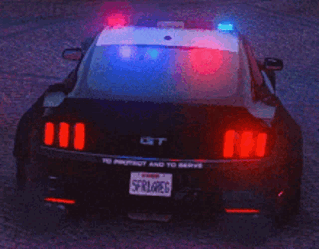 a black police car with a license plate that says scrl6reg