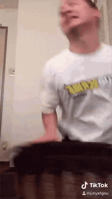 a man wearing a white shirt with a yellow nirvana logo