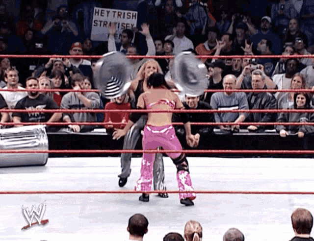 a wrestling ring with a sign that says hey trish stratsey