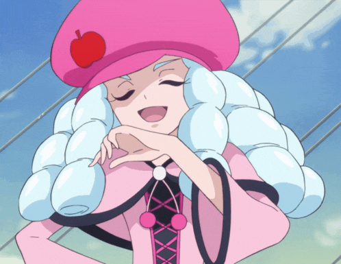 a girl wearing a pink hat with an apple on it is smiling