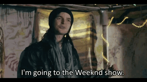 a man in a beanie and scarf is saying i 'm going to the weekend show