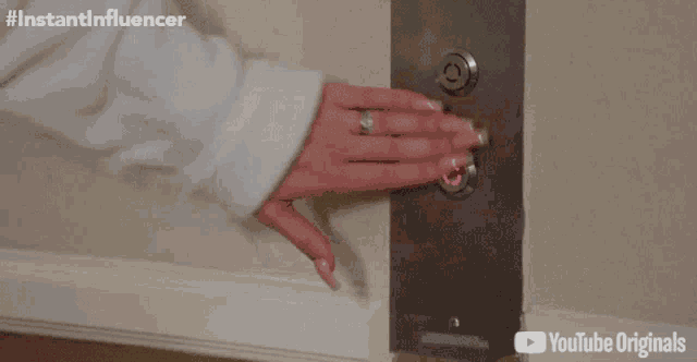 a person pressing an elevator button with youtube originals written on the bottom