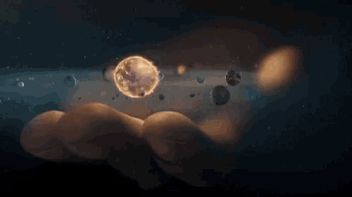 a hand is holding a planet in the middle of a universe