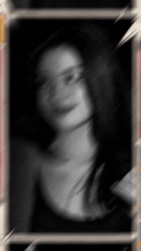 a blurry picture of a woman 's face in a black and white photo