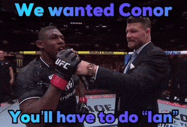 a man in a suit holds a fighter 's hand and says we wanted conor you 'll have to do lan