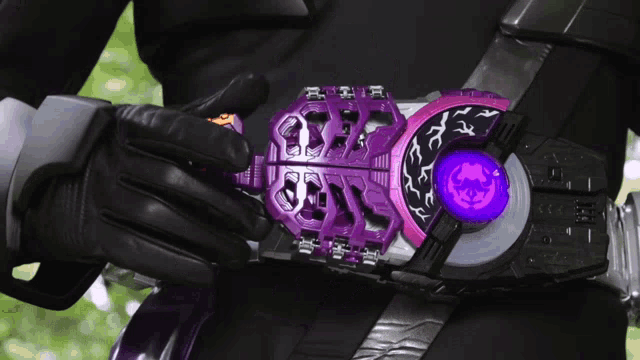 a person is wearing a purple belt with a purple button that says ' a ' on it