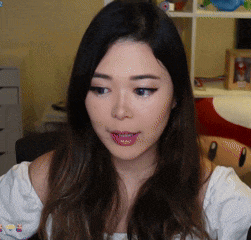 a close up of a woman 's face in front of a shelf