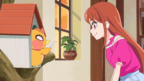 a girl in a pink shirt is standing next to a cartoon character