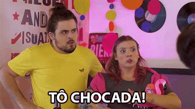 a man and a woman are standing next to each other and the woman is holding a flamingo float and says to chocada