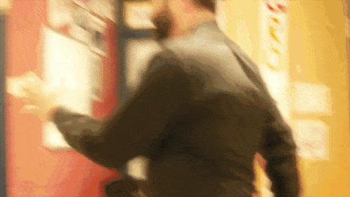 a blurry picture of a man in a suit walking