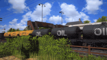 a train carrying oil tanks on the tracks