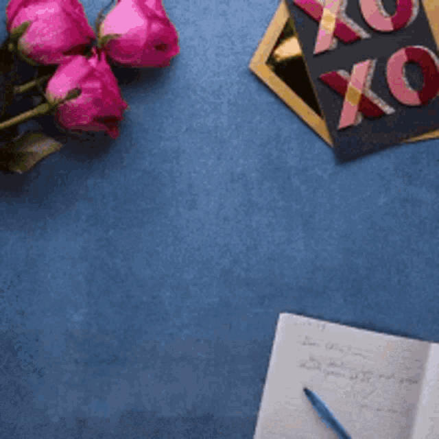 a blue background with pink roses and a card that says xoxo on it