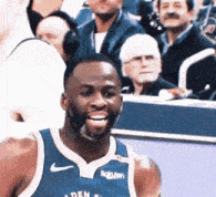 a basketball player wearing a blue jersey with rakuten on it
