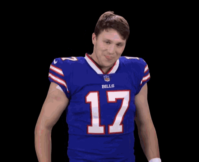 a man wearing a blue bills jersey makes a face