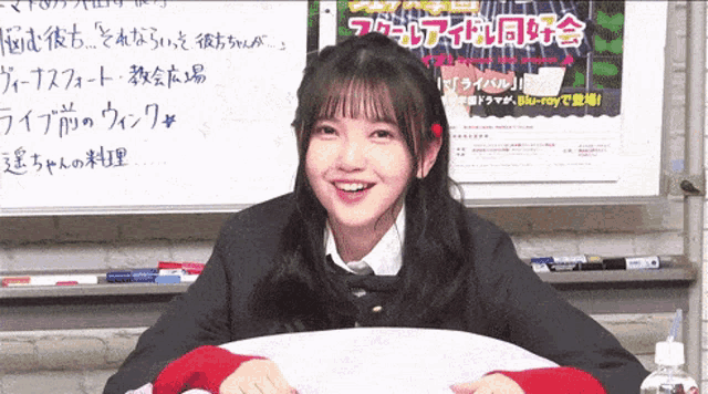 a girl is smiling in front of a sign that says " blu-ray " on it