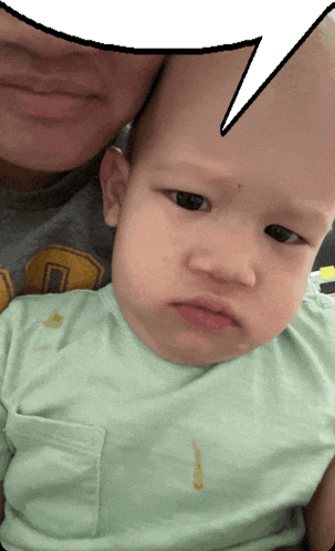 a woman holding a baby with a speech bubble above it
