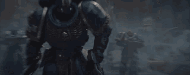 a man in a helmet is holding a spear in his hand while standing in a pile of rocks .