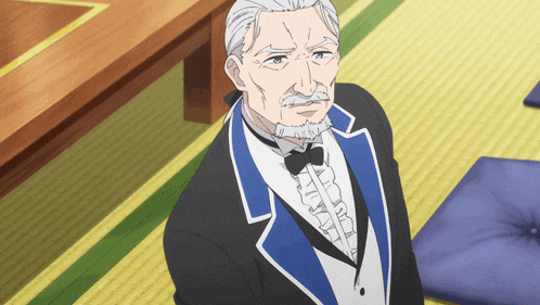 a man in a tuxedo with a bow tie is sitting on a rug
