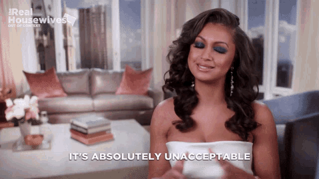 a woman sitting in a living room says it 's absolutely unacceptable