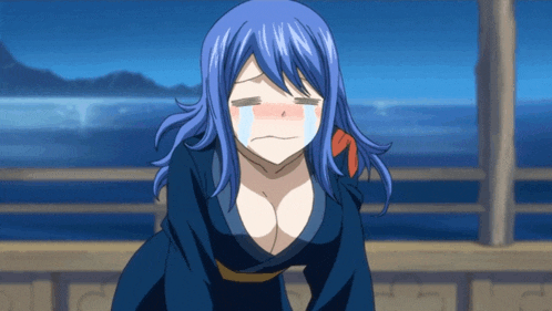 a girl with blue hair is crying with her eyes closed and a red spot on her cheek