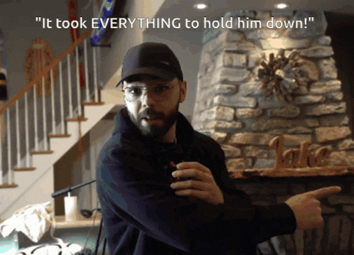 a man standing in front of a stone fireplace with the words " it took everything to hold him down "