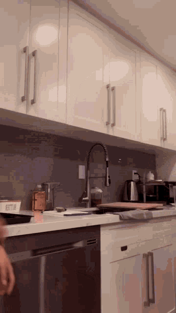 a kitchen with white cabinets and stainless steel appliances and a box that says bitter