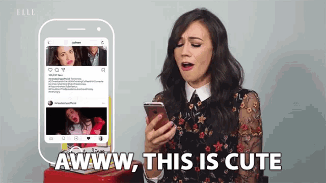 a woman is looking at her phone and saying awww this is cute
