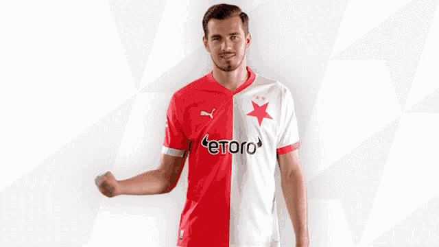 a man wearing a red and white jersey with etoro on the front