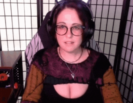 a woman wearing glasses and headphones is sitting in front of a purple screen .