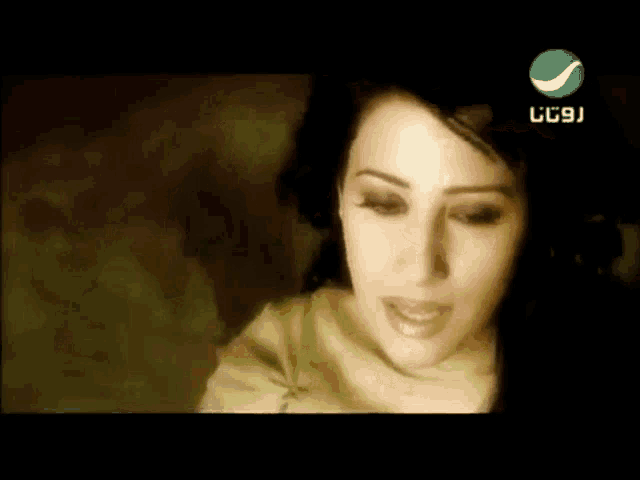 a close up of a woman 's face with a green circle in the corner that says lc9j