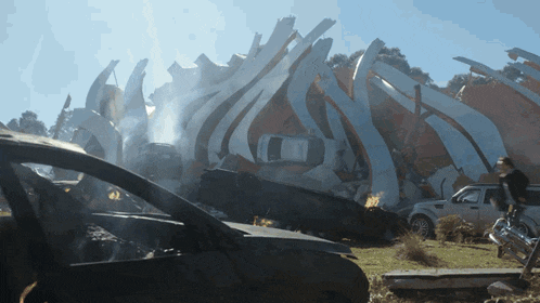 a car is sitting in front of a building that has been demolished