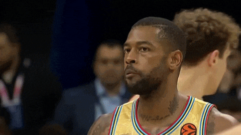 a man with a beard is wearing a yellow jersey with a basketball on it