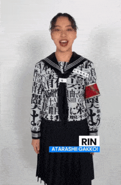 a woman wearing a black and white shirt with the name rin on the bottom