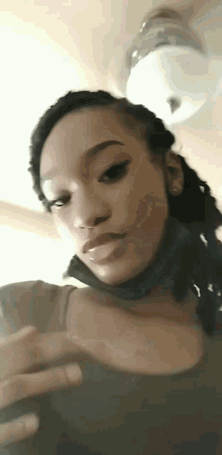 a close up of a woman wearing a choker and looking at her phone