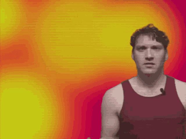 a man wearing a red tank top is standing in front of a yellow and red background