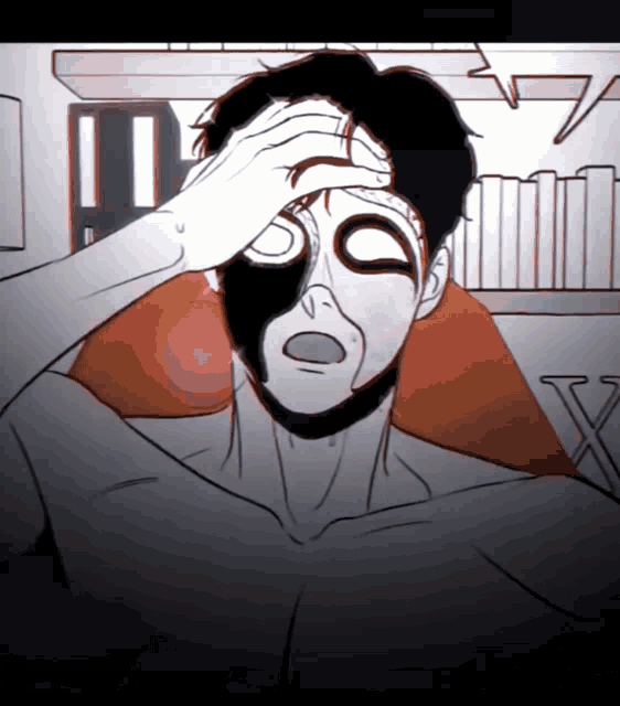 a man with a black mask on his face holds his head