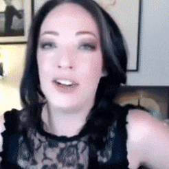 a close up of a woman 's face with a black lace top on